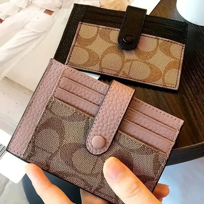 Compact RFID wallet for women in stylish design, featuring card slots and a button closure on a wooden table.