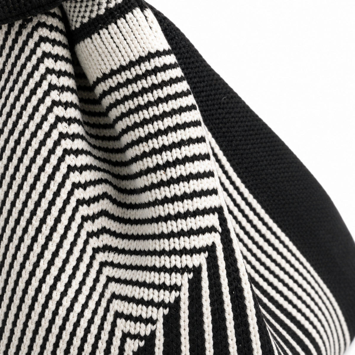 Close-up of The Labyrinth black handbag showcasing its unique striped pattern, a stylish washable black handbag design.