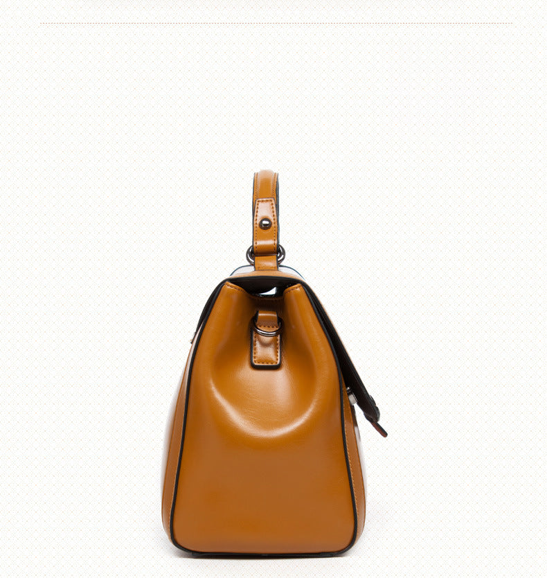 Stylish black and earthy yellow genuine leather shoulder handbag with cover wrapping design.