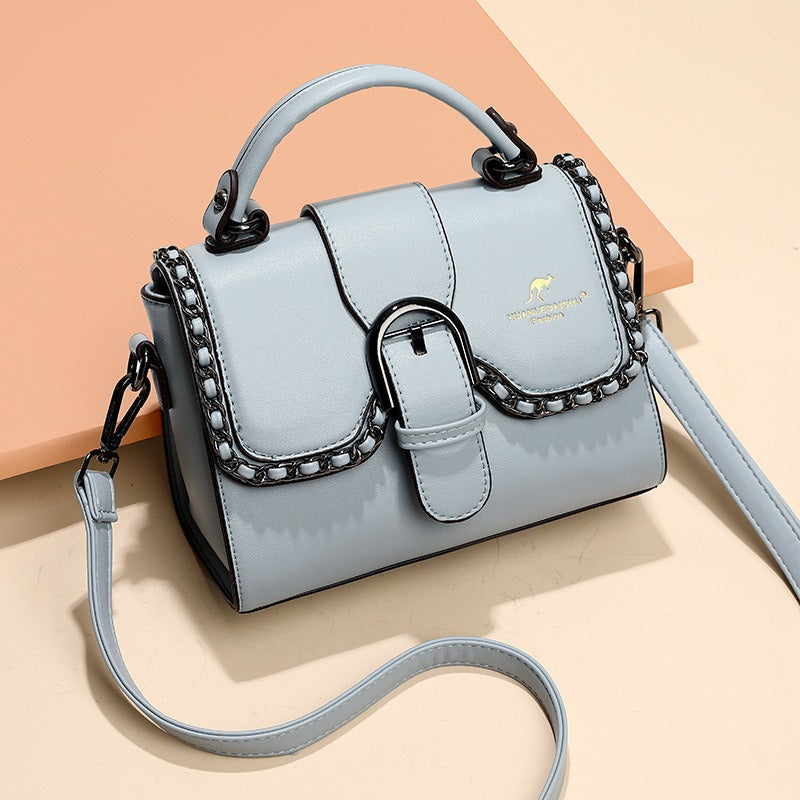 Luxury PU shoulder bag for women in light blue with chain detailing and magnetic buckle closure.